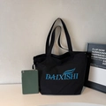 Black canvas tote bag with blue logo and drawstring detail for daily commuting - Black