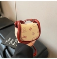 Detail view of mini saddle bag featuring beige leather with red trim and bear print - Red