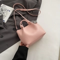 Light pink pebbled leather bucket bag with knot handle and silver ball charm detail - Pink with Pendant