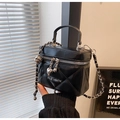 Nahaufnahme der schwarzen Stepptasche mit Herzanhänger und Leder-Kettenträger - Schwarz