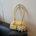 Bright yellow pebbled leather bowling bag with twin front pockets and pearl bow charm - Yellow with Pendant