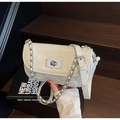 Detailed view of cream quilted leather texture and silver twist lock on mini chain bag - Off-white