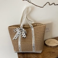 Straw tote bag featuring silver sequin straps and a black and white polka dot ribbon bow - Silver