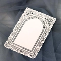 Close-up of laser-cut lace paper with intricate floral patterns and elegant arch design - Ivory