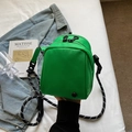 Chic vibrant green nylon crossbody bag featuring a stylish black and white braided rope strap - Green