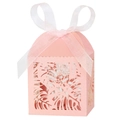 Close-up of pink laser-cut candy box with tropical leaf pattern and white organza ribbon - Pink