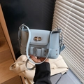 Chic light blue leather crossbody bucket bag featuring silver hardware and a turn-lock closure - Blue