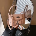Light pink leather crossbody bucket bag with silver eyelet belts and metal turn-lock - Pink