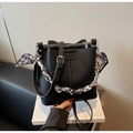 Detailed shot of black litchi pattern bucket bag with heart-printed silk scarf handle - Black