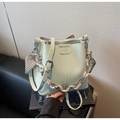 Detail of light green pebble leather bucket bag with decorative heart print silk scarf - Blue