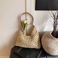 Beige woven straw tote bag with brown leather strap and intricate hollow crochet texture - Off White