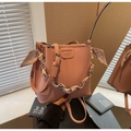 Pink lychee grain leather bucket bag with silk scarf handle and bow details - Pink