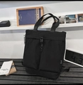 Dettaglio della borsa tote in nylon nero con fibbia funzionale e design industriale - Nero