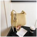 Cream yellow bucket bag with pebbled leather texture and decorative knot strap detail - Yellow