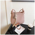 Pink lychee grain leather mini bag with gold text detail and striped ribbon charm - Purple