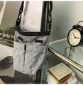 Detail of grey crossbody phone bag with two 3D pockets and adjustable black strap - Gray