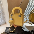 Bright yellow lychee grain leather crossbody bag with silver hardware and heart charm - Yellow