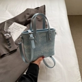 Light blue denim bucket bag with silver studs and adjustable leather shoulder strap - Blue Without Charm