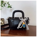 Elegant black oil-wax leather Boston handbag with lace bow and pearl charm accents - With Charm / Black