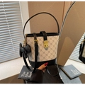 Detailed view of color-block bucket bag with letter print and golden twist lock closure - Black (With Charm)
