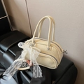 Cream mini crossbody bag featuring a lace bow and pearl pendant with litchi grain leather - White with Pendant