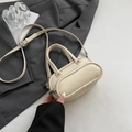 Chic beige lychee textured cross-body bag with round silhouette and double handles - White Without Pendant