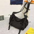 Versatile black nylon crossbody dumpling bag with adjustable strap and buckle closure - Black