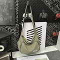 Close-up of olive green waterproof nylon crossbody bag with adjustable strap and front zip - Green