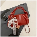 Red pleated bucket bag with pearl charm and lace bow on a dark blazer background - Red with Pendant