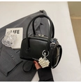 Detail view of black glossy Boston bag with pearl heart charm and silver zippers - With Charm / Black