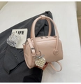 Pink textured Boston bag with pearl heart pendant and adjustable strap for women - With Charm / Pink