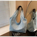 Light blue denim tote bag with black leather straps on a minimalist indoor setup - Sky Blue
