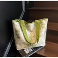 Large canvas tote bag with bamboo print and green handles on wood surface - Green