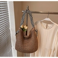 Detailed close-up of handmade straw tote bag with black and white striped shoulder strap - Striped Ribbon Khaki