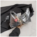 Detail of silver metallic shoulder bag with pink heart charm and braided cord on a blazer - With Pendant / Silver