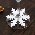 White snowflake paper wine glass card for Christmas table decorations on wooden background - White
