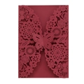 Close-up of laser-cut burgundy wedding invitation featuring intricate butterfly floral pattern - Dark Red