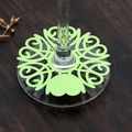 Close-up of laser-cut green vine wine glass place cards on a dark wooden table - Dark Green