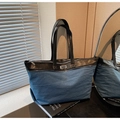 Detail of large denim and leather patchwork tote bag with metal plaque and long straps - Light Blue