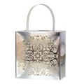 Close-up of laser-cut hollow lace pattern on silver metallic wedding candy gift box - Reflective Silver
