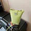 Light green pebble leather bucket bag for women with silver twist lock and slim strap - With Charm / Green