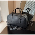Matte black leather travel duffel bag with dual handles and detachable shoulder strap - Black