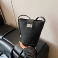 Black litchi grain leather bucket bag with a silver metal twist lock and shoulder strap - With Charm / Black