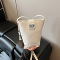 White litchi pattern bucket bag with silver metal twist lock and drawstring detail - With Charm / White