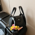 Black pebbled leather bucket bag with silver buckle and yellow elephant charm - Black