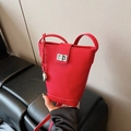 Chic red lychee grain leather bucket bag with silver twist lock and metallic ball charm - With Charm / Red