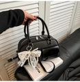 Close-up of black bowling bag with lace pearl bow charm and dual round handles - With Lace Pendant / Black