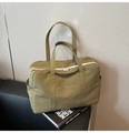 Close-up of olive green nylon tote bag featuring white zipper and embroidered quote detail - Army Green