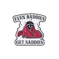 Punk style skull badge featuring a character in red blanket with 'Even Baddies Get Saddies' text - Raccoon Style (QHXZ3392)