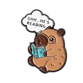 Cute Capybara enamel pin featuring a brown water pig reading a blue book on white background - Reading Capybara Style (QHXZ3662)